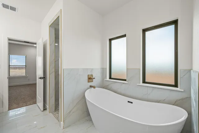 a white bath tub sitting next to a bathroom sink