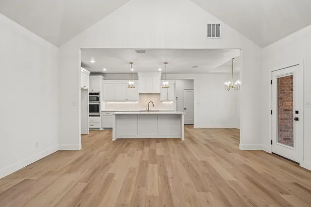 a large kitchen with a lot of counter space and stainless steel appliances