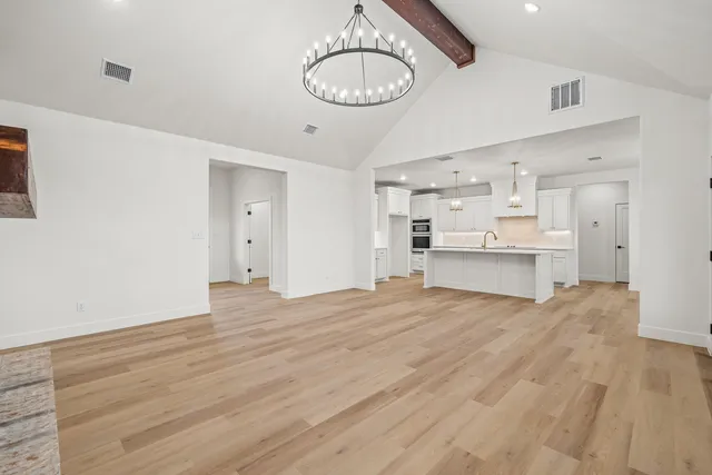 a view of a kitchen with wooden floor and a sink