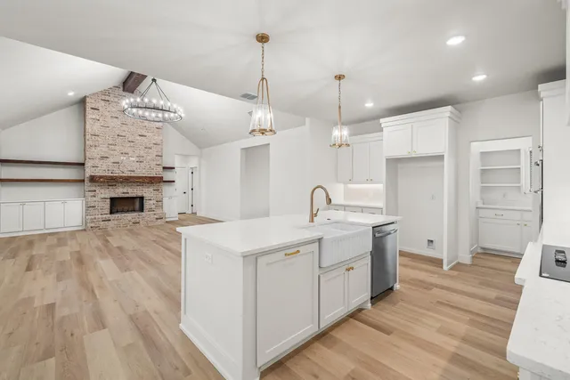 a large white kitchen with stainless steel appliances