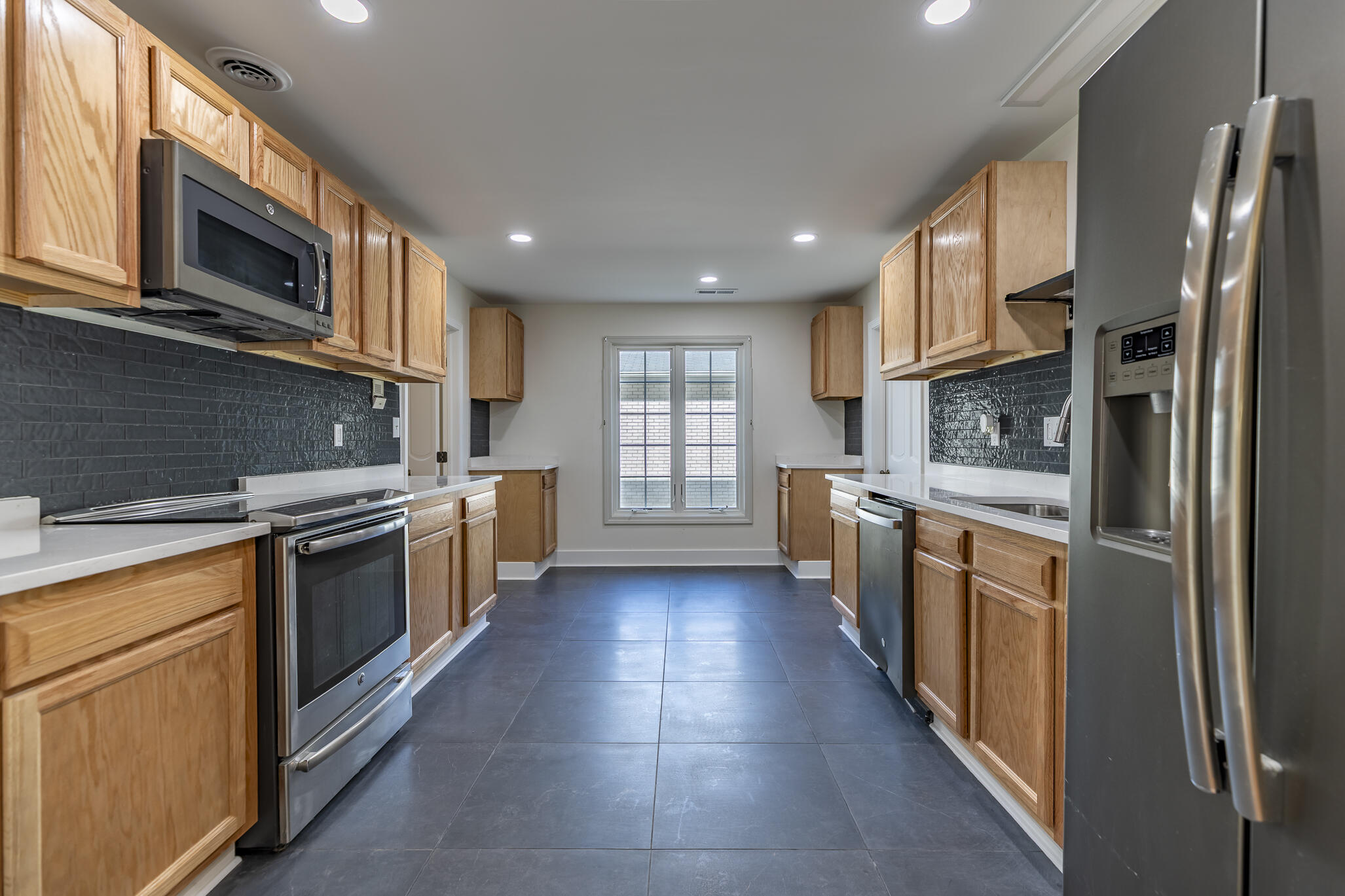 2255 Bordeaux, Unit B1 Highland, IN 46322 - Photo 25 of 49 a large kitchen with stainless steel appliances granite countertop a stove a sink dishwasher and a refrigerator with wooden cabinets