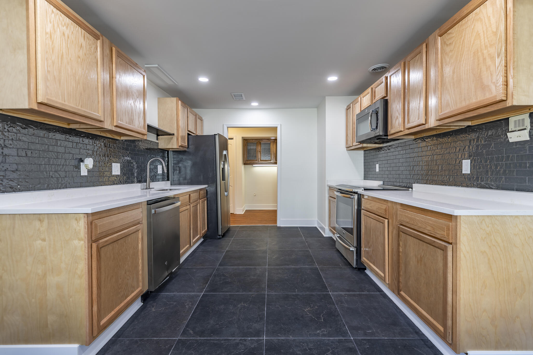 2255 Bordeaux, Unit B1 Highland, IN 46322 - Photo 26 of 49 a kitchen with stainless steel appliances granite countertop a sink a stove and a refrigerator