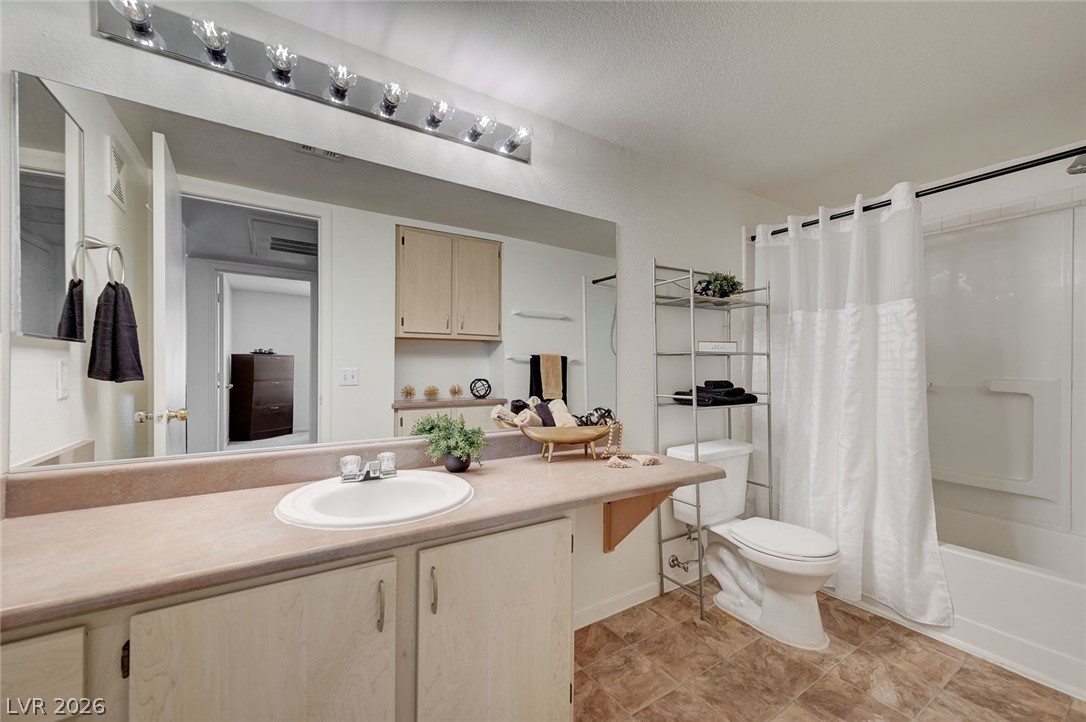 555 East Silverado Ranch Boulevard, Unit 2124 Las Vegas, NV 89183 - Photo 30 of 47 Functional bathroom features a well-lit vanity, practical storage, and a combined tub and shower.