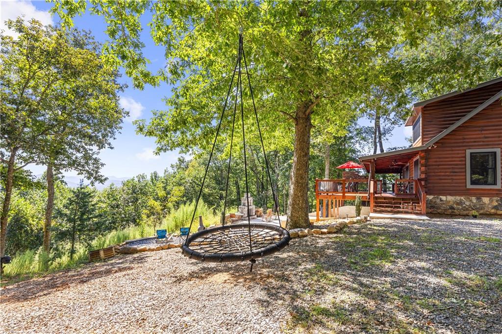832 Scenic Mountain View Road Blue Ridge, GA 30513 - Photo 46 of 56 a view of a backyard with table and chairs and a fire pit