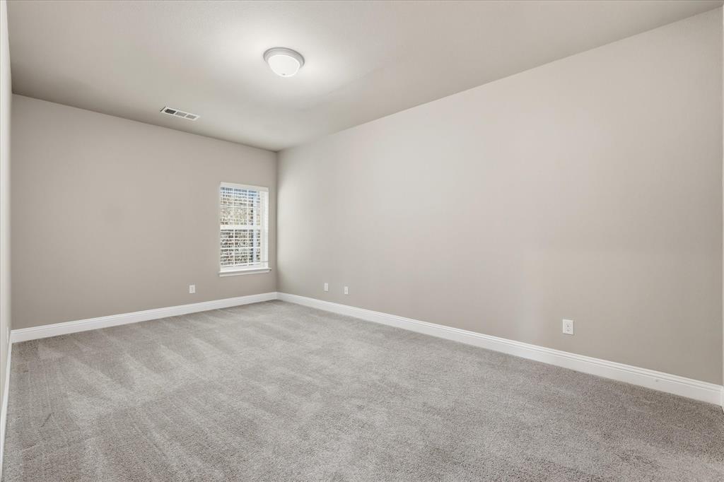 768 Huntingdon Street Coppell, TX 75019 - Photo 29 of 37 Generously sized secondary bedroom with plush carpet, neutral walls, crisp white baseboards, and a flexible layout for guests, kids, or a home office.