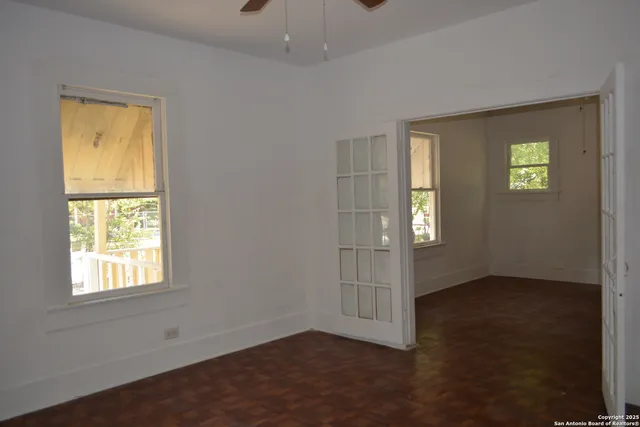 an empty room with windows and closet