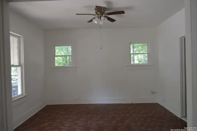 an empty room with windows and closet