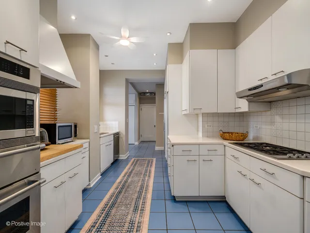 a view of an empty room with window and cabinet