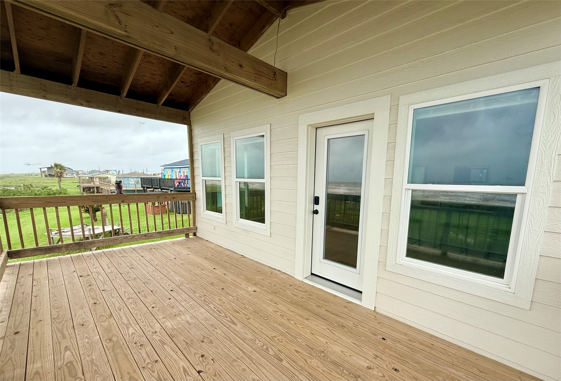 2154 County Road 230 Sargent, TX 77414 - Photo 13 of 30 a view of balcony with floor to ceiling windows with wooden floor