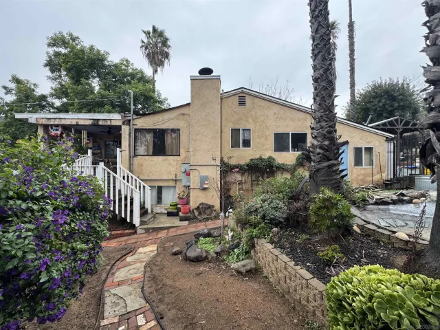a view of house with outdoor space and garden