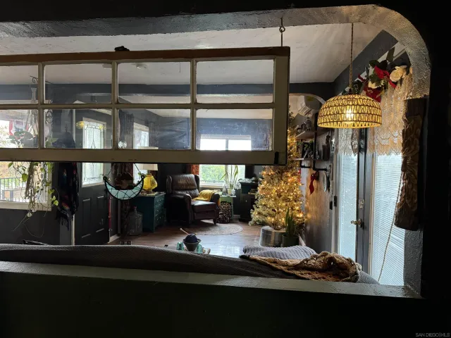 a living room with a bed furniture and a window