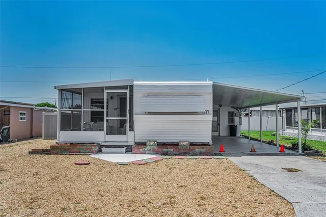 a front view of a house with garden and plants