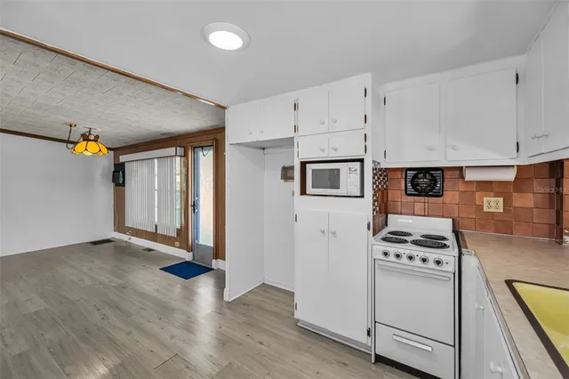 a kitchen with granite countertop a stove and a refrigerator