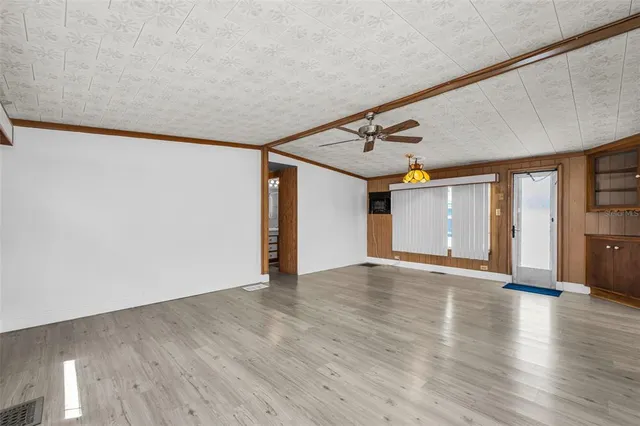 a view of an empty room with wooden floor