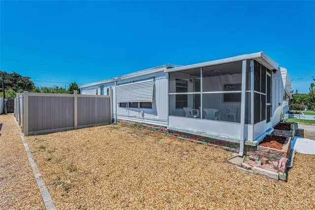 a view of backyard with wooden fence and a large window