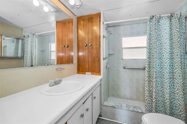 a view of a hallway with wooden floor and brick walls