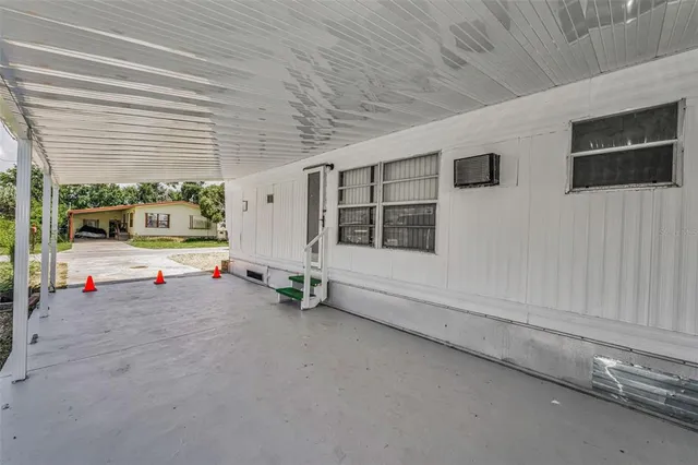 a backyard of a house with barbeque oven table and chairs