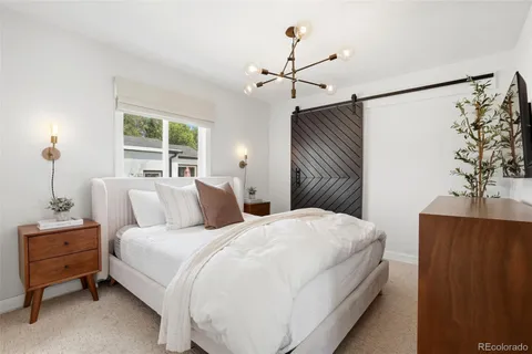 a bedroom with a bed and a chandelier