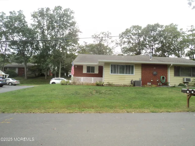 a front view of a house with a garden and yard