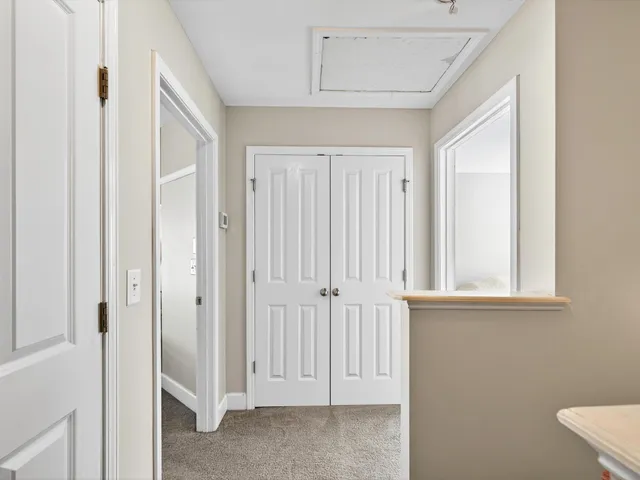 an entryway with a cabinet and mirror