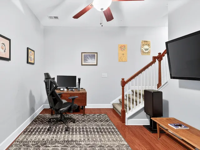 a workspace with wooden floor and a rug