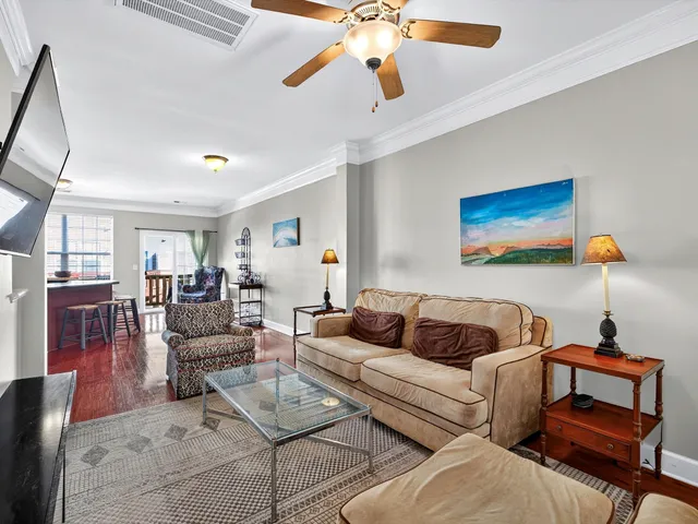 a living room with furniture and wooden floor