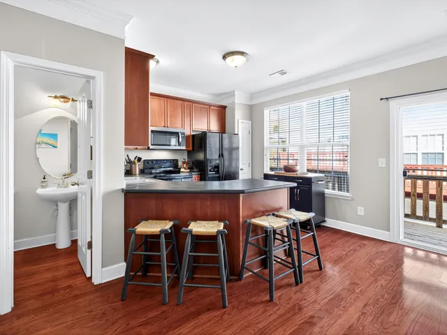 a dining room with furniture and wooden floor