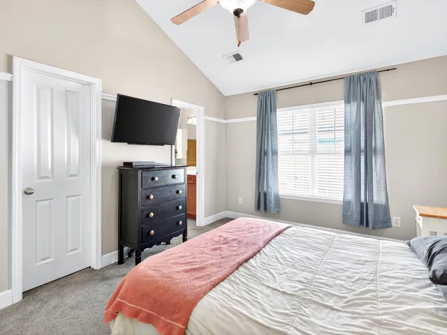 a bedroom with a bed and a flat screen tv in it