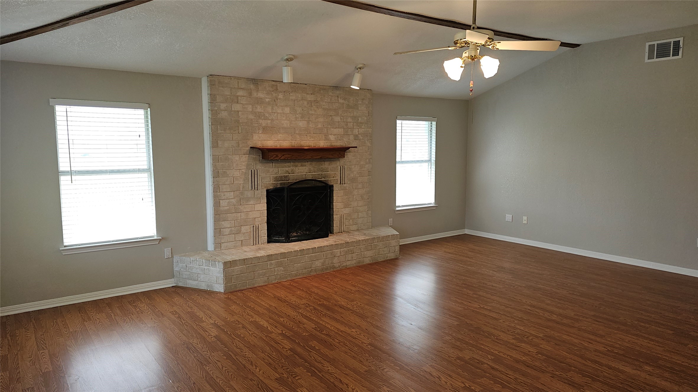 16 Brenda Lane Round Rock, TX 78665 - Photo 12 of 40 an empty room with wooden floor fireplace and windows