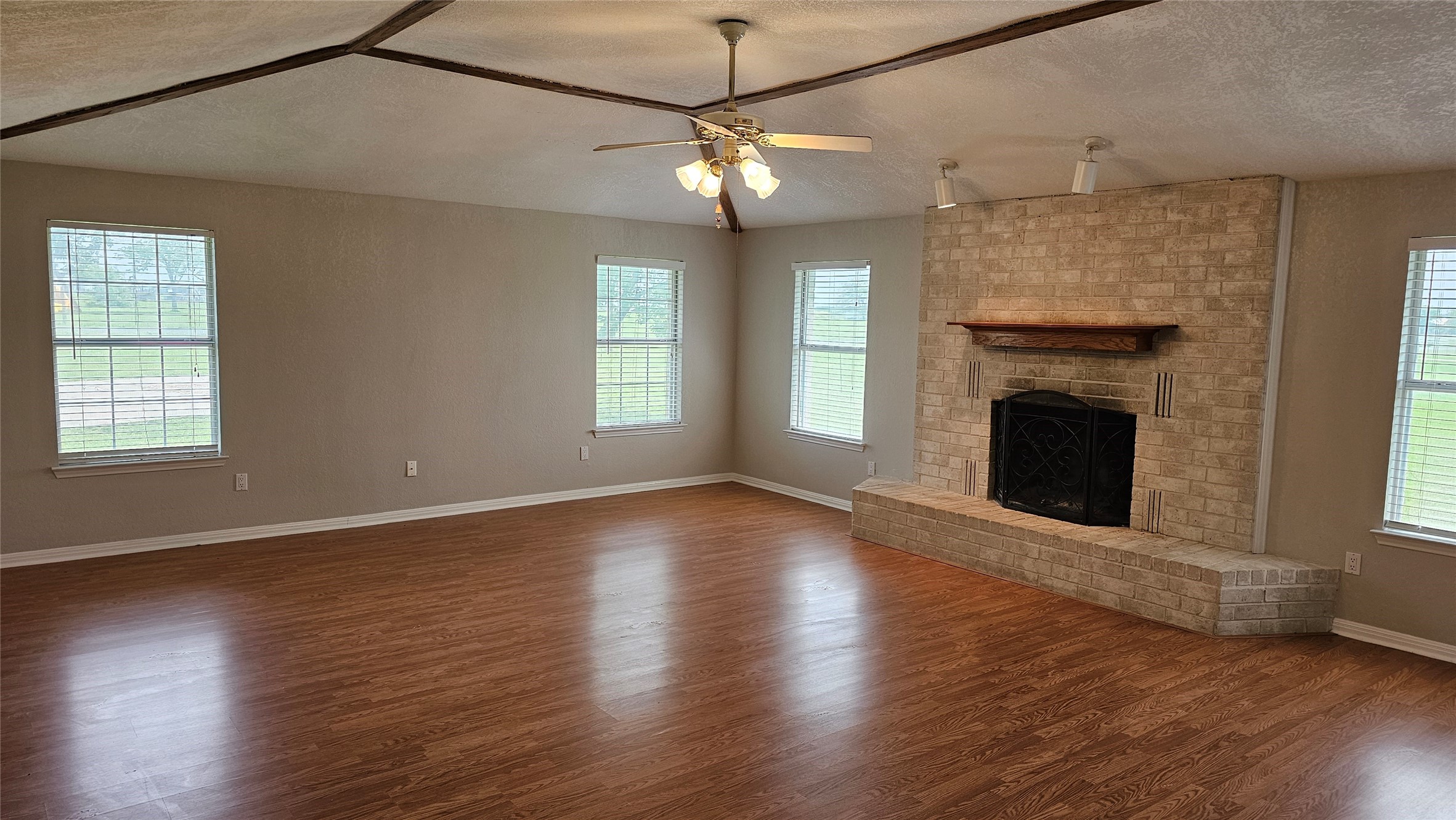 16 Brenda Lane Round Rock, TX 78665 - Photo 10 of 40 a view of an empty room with wooden floor fireplace and a window