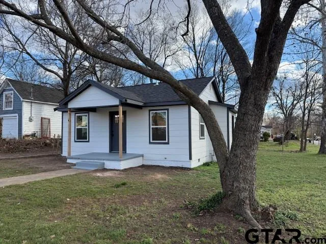 a front view of house with yard and green space