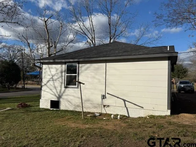 a big house with trees in front of it