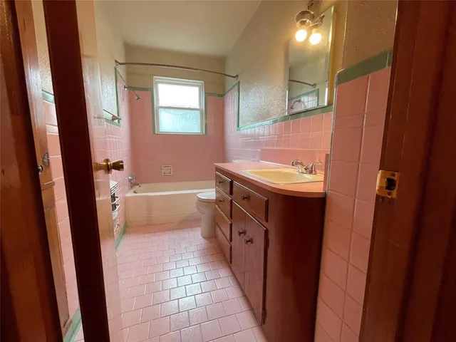 a bathroom with a sink a toilet and a shower