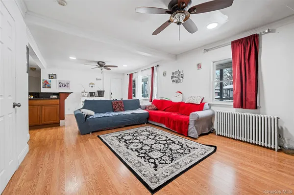 a living room with furniture and kitchen view