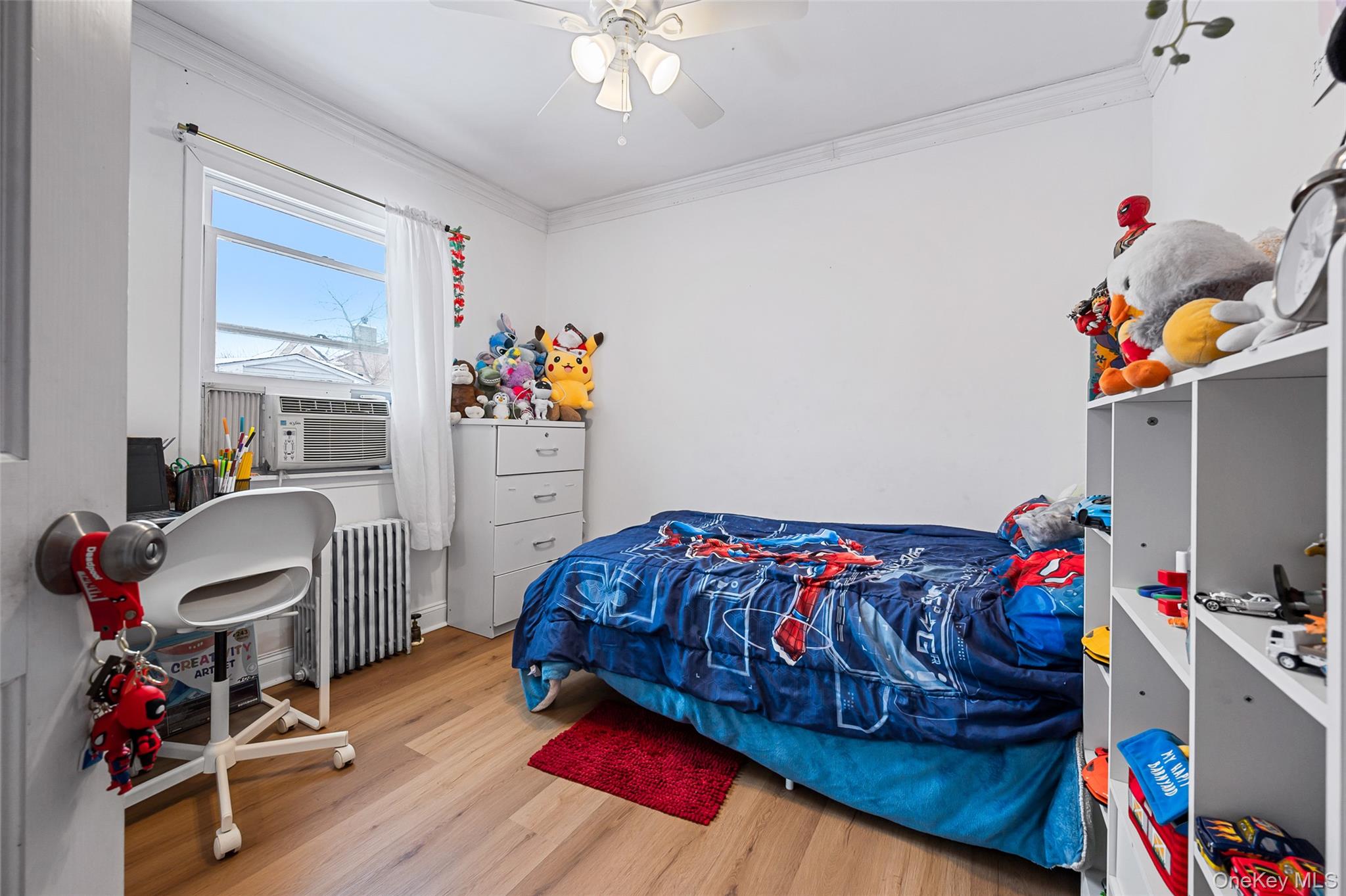 8 George Drive Mastic, NY 11950 - Photo 18 of 30 a bedroom with a bed and a chandelier