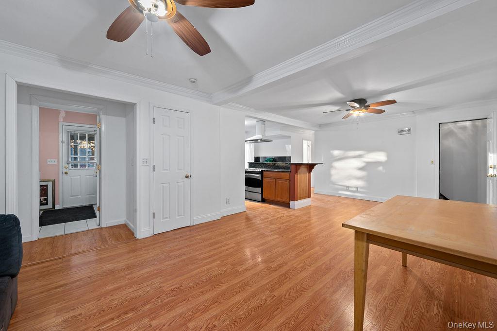 8 George Drive Mastic, NY 11950 - Photo 22 of 39 a view of kitchen and empty room with wooden floor