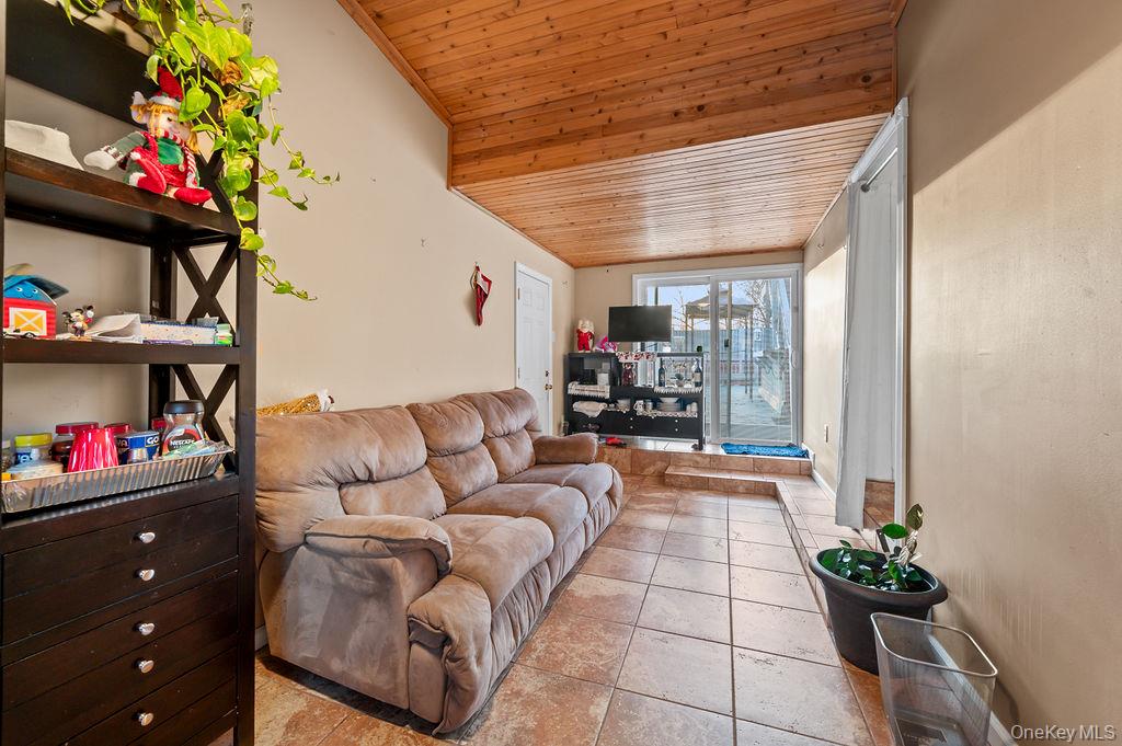 8 George Drive Mastic, NY 11950 - Photo 24 of 39 a living room with furniture and a potted plant