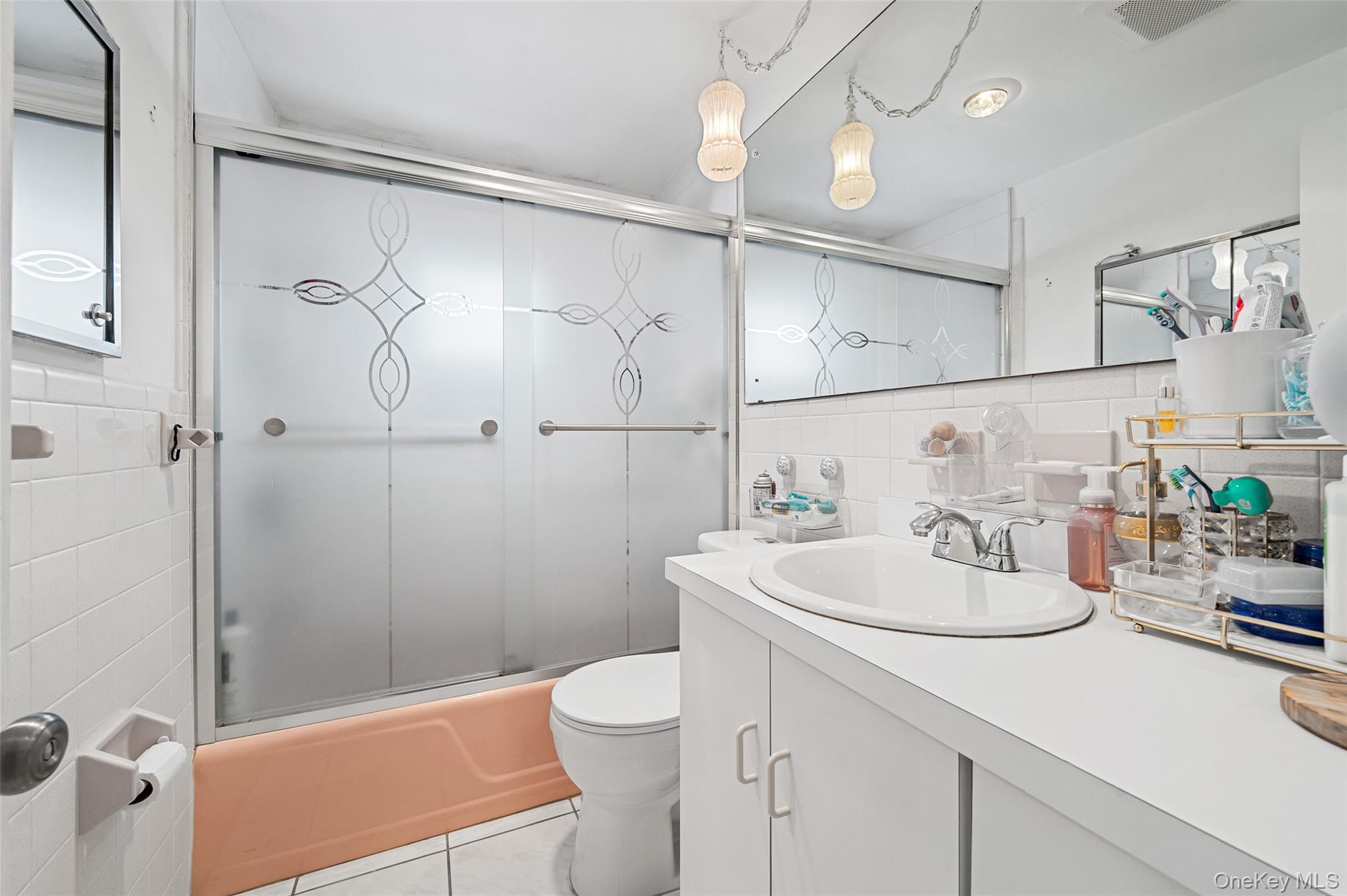 8 George Drive Mastic, NY 11950 - Photo 25 of 30 a bathroom with a sink a toilet and shower
