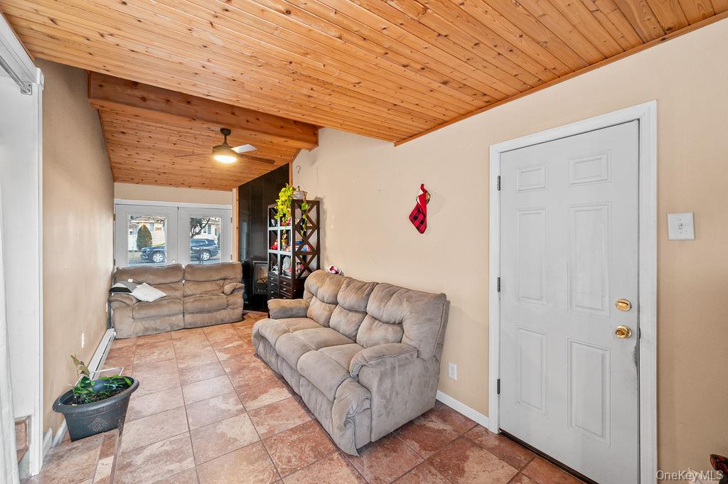 8 George Drive Mastic, NY 11950 - Photo 25 of 39 a living room with furniture and a potted plant