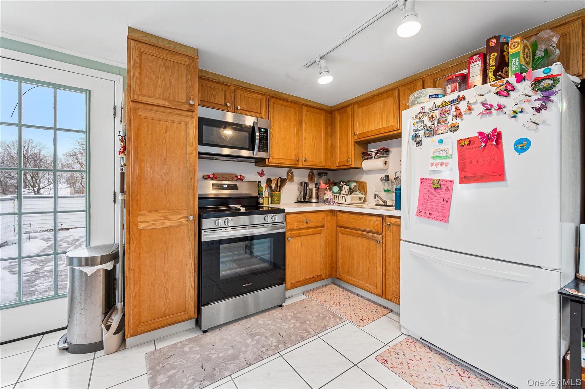 8 George Drive Mastic, NY 11950 - Photo 28 of 30 a kitchen with a refrigerator and a sink