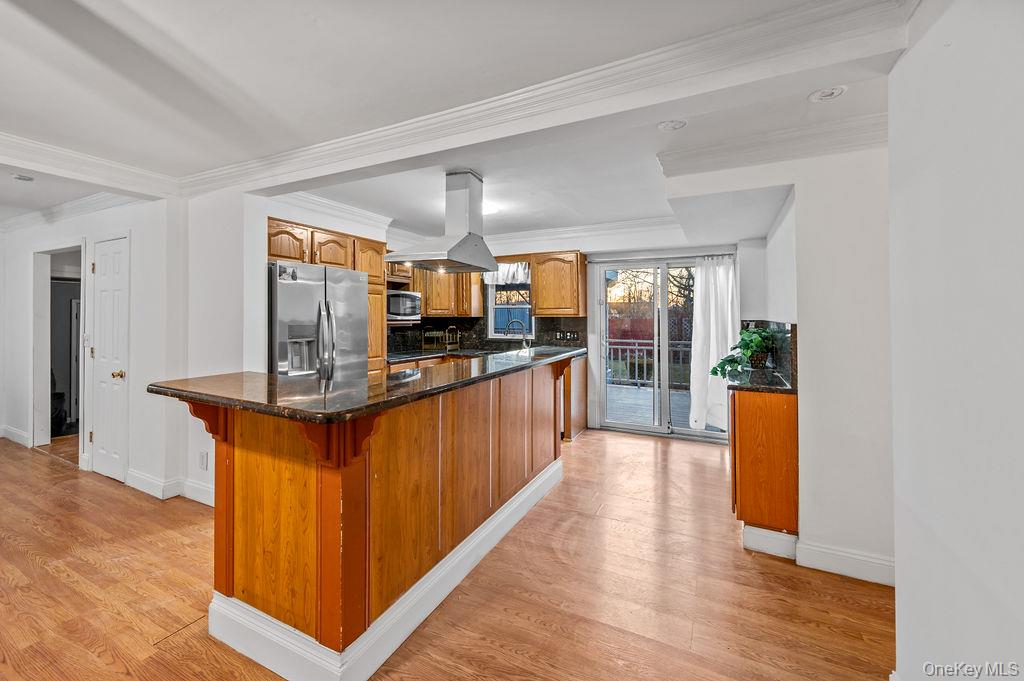 8 George Drive Mastic, NY 11950 - Photo 29 of 39 a kitchen with stainless steel appliances granite countertop a stove a sink and a refrigerator