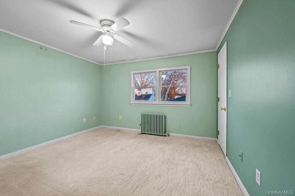 8 George Drive Mastic, NY 11950 - Photo 30 of 39 an empty room with fan and window