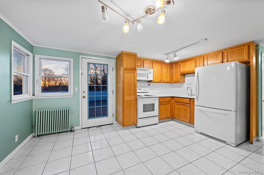 8 George Drive Mastic, NY 11950 - Photo 35 of 39 a kitchen with stainless steel appliances granite countertop a refrigerator and a sink