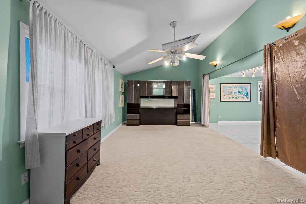 8 George Drive Mastic, NY 11950 - Photo 37 of 39 a view of a kitchen with furniture and a ceiling fan