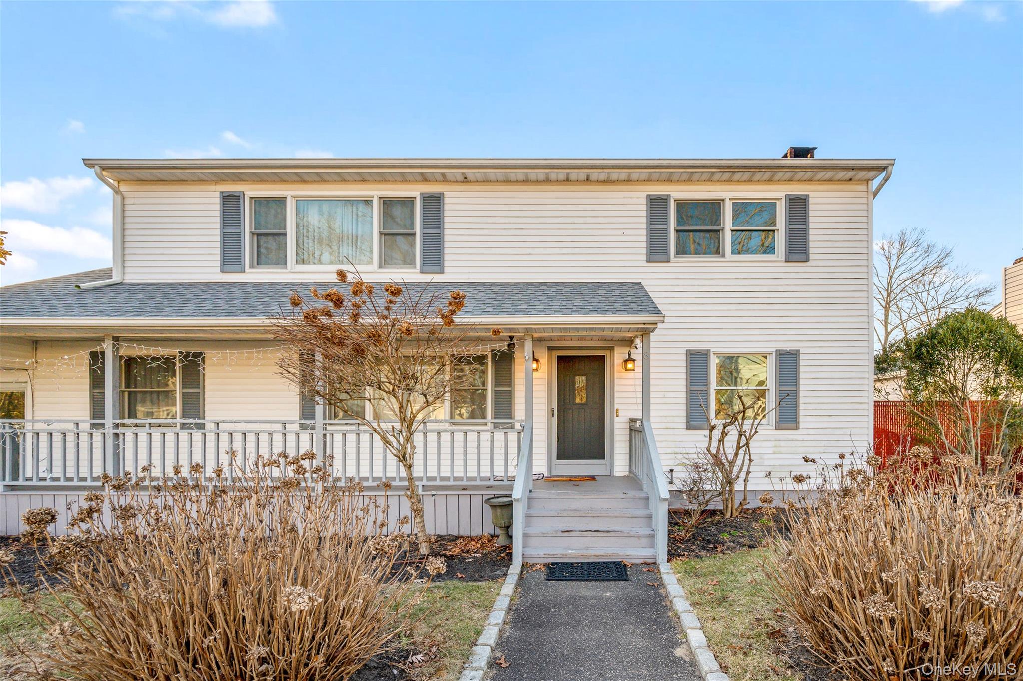 8 George Drive Mastic, NY 11950 - Photo 4 of 30 front view of a house with a porch