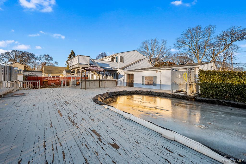 8 George Drive Mastic, NY 11950 - Photo 10 of 39 a view of a house with pool and sitting area