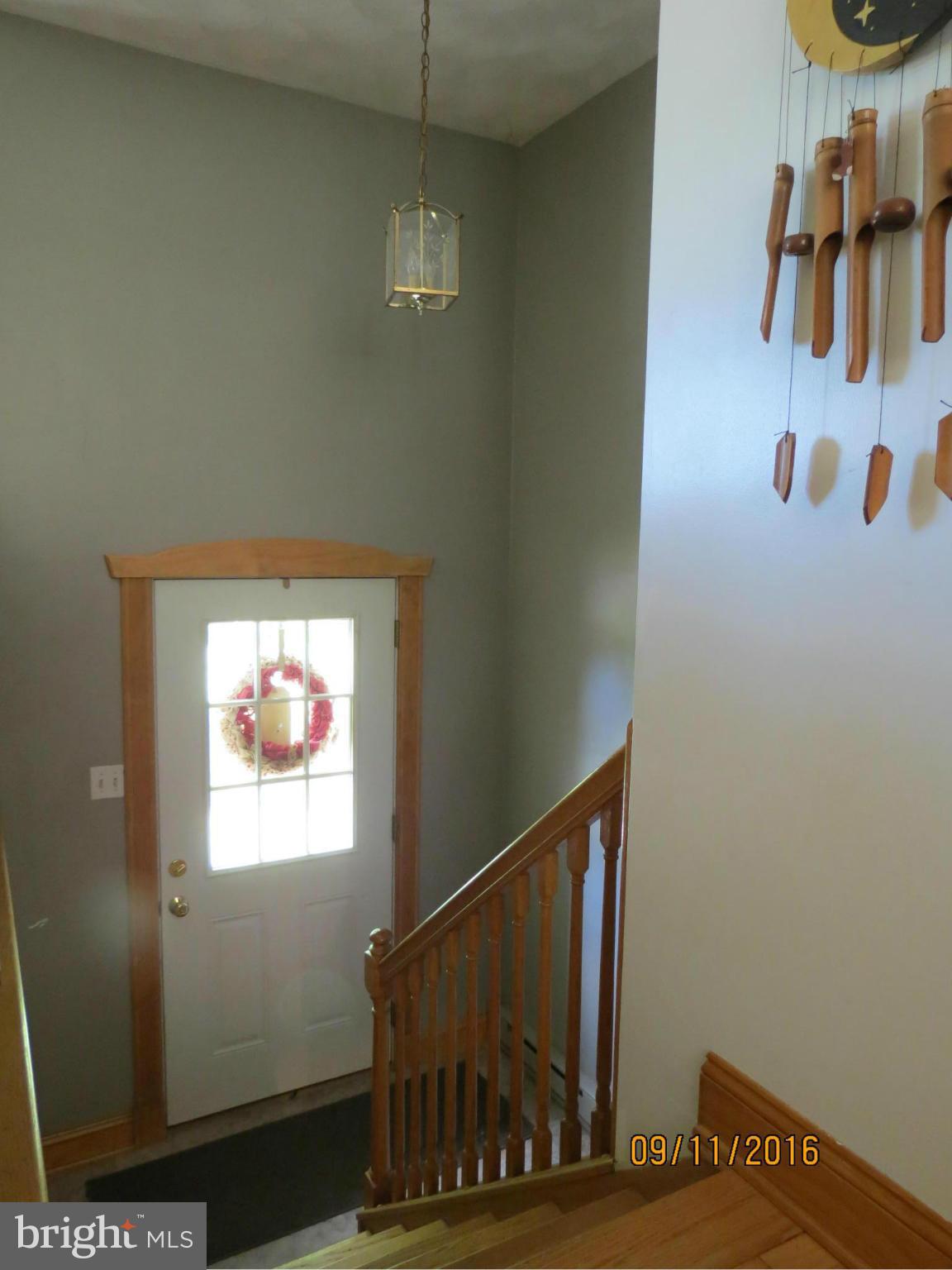 2017 Garrett Road Manchester, MD 21102 - Photo 9 of 30 Bright Entry Way with Oak Stairs and Handrail