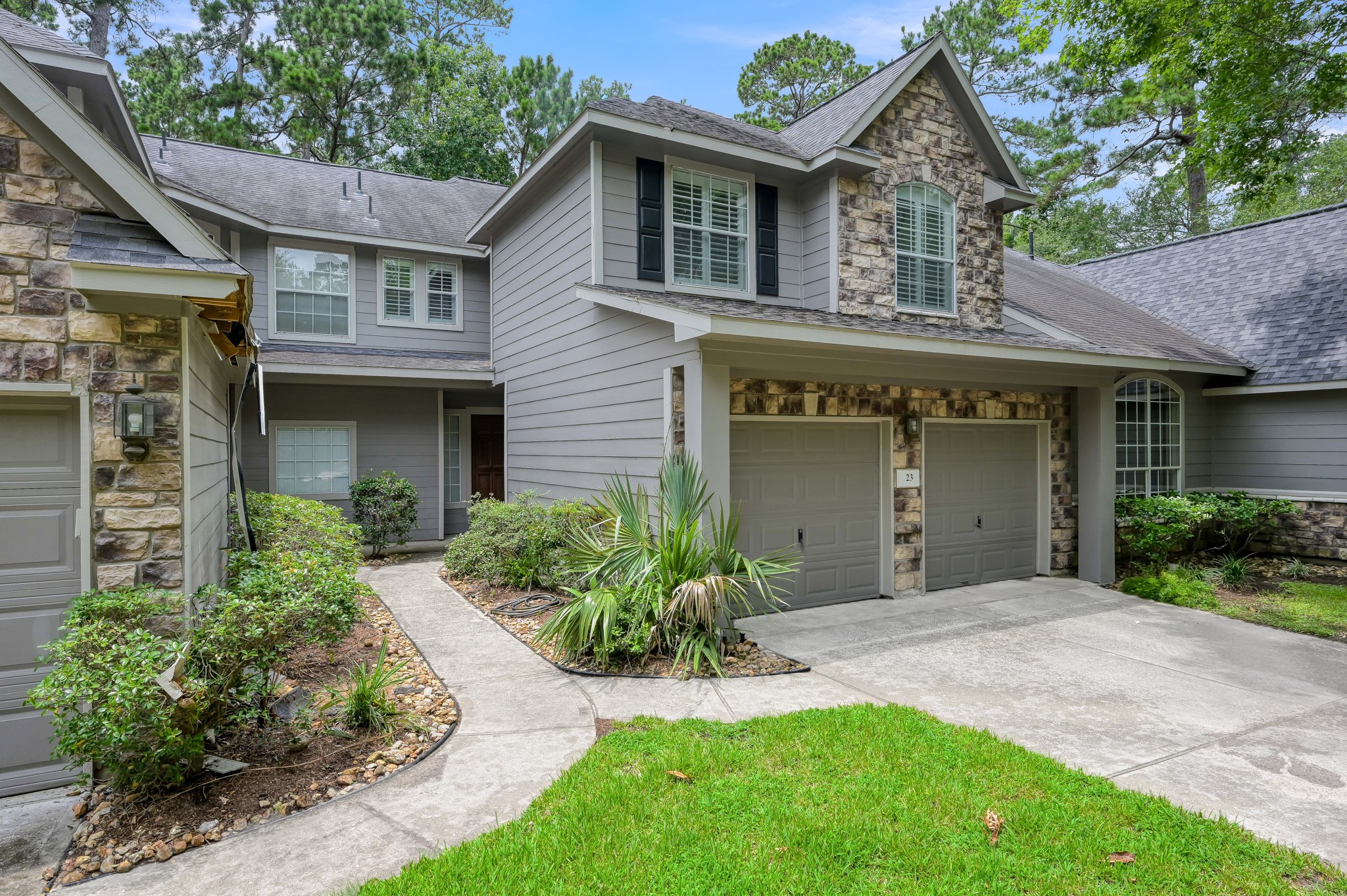 23 Alderon Woods Place Spring, TX 77382 - Photo 2 of 25 a front view of a house with a garden and plants