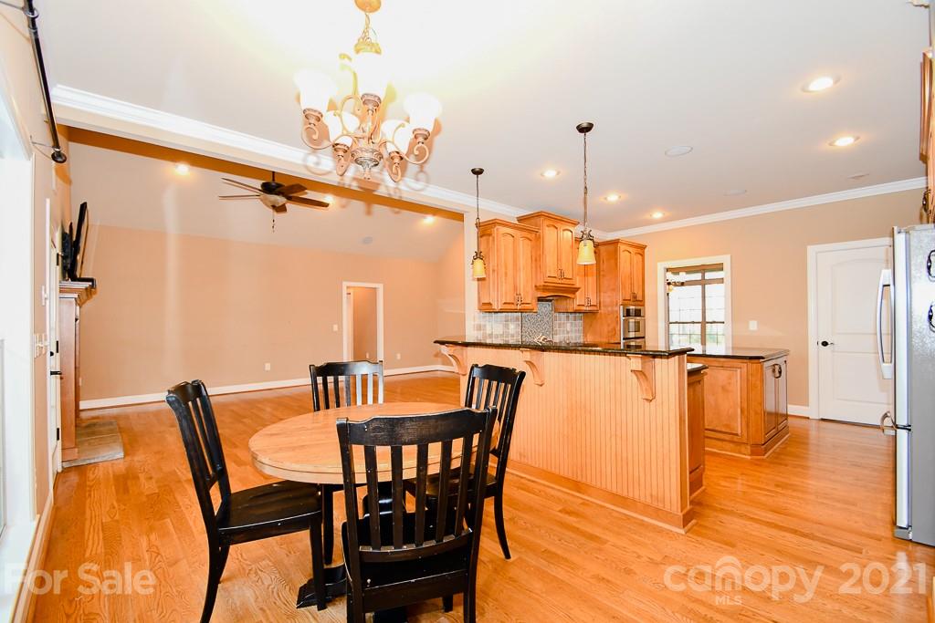 721 Roy Kindley Road Monroe, NC 28110 - Photo 12 of 32 a dining room with furniture and a chandelier