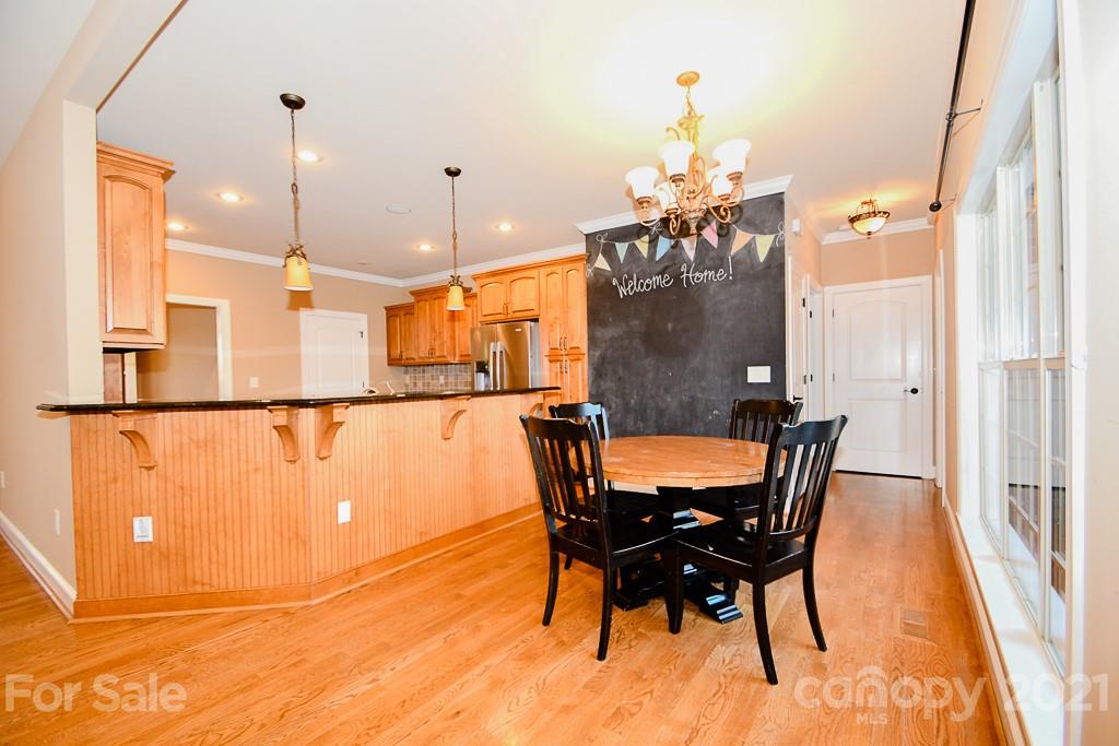 721 Roy Kindley Road Monroe, NC 28110 - Photo 13 of 32 a view of a dining room with furniture and a chandelier